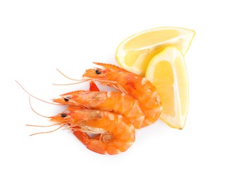 Photo of Delicious cooked shrimps and lemon isolated on white, top view