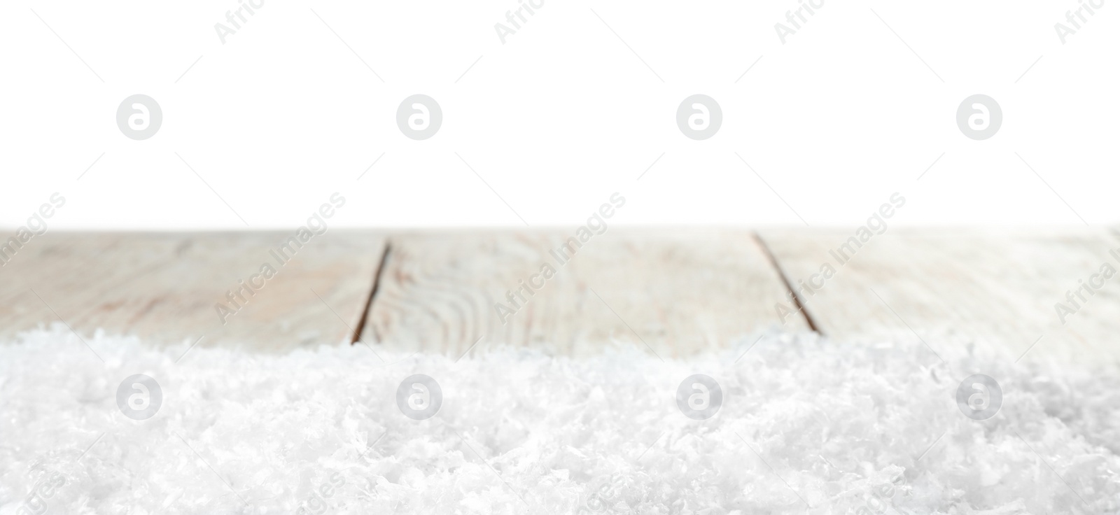 Photo of Heap of snow on wooden table against white background. Christmas season