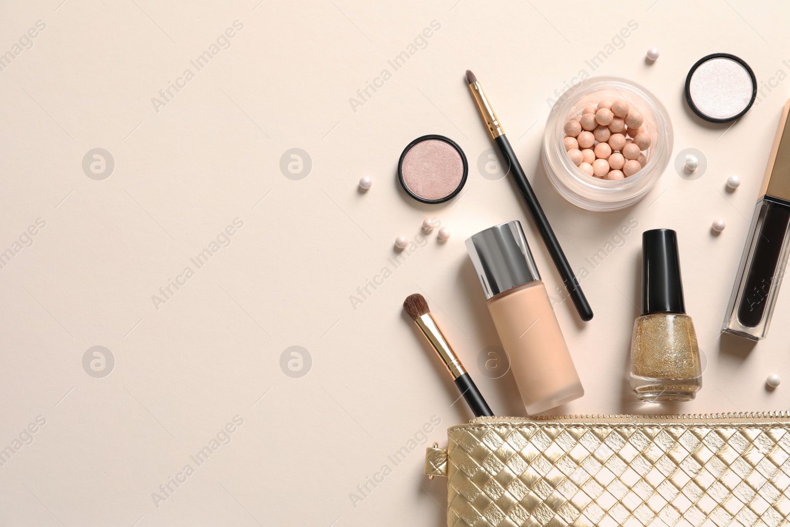 Photo of Cosmetic bag and different luxury makeup products on color background, flat lay. Space for text