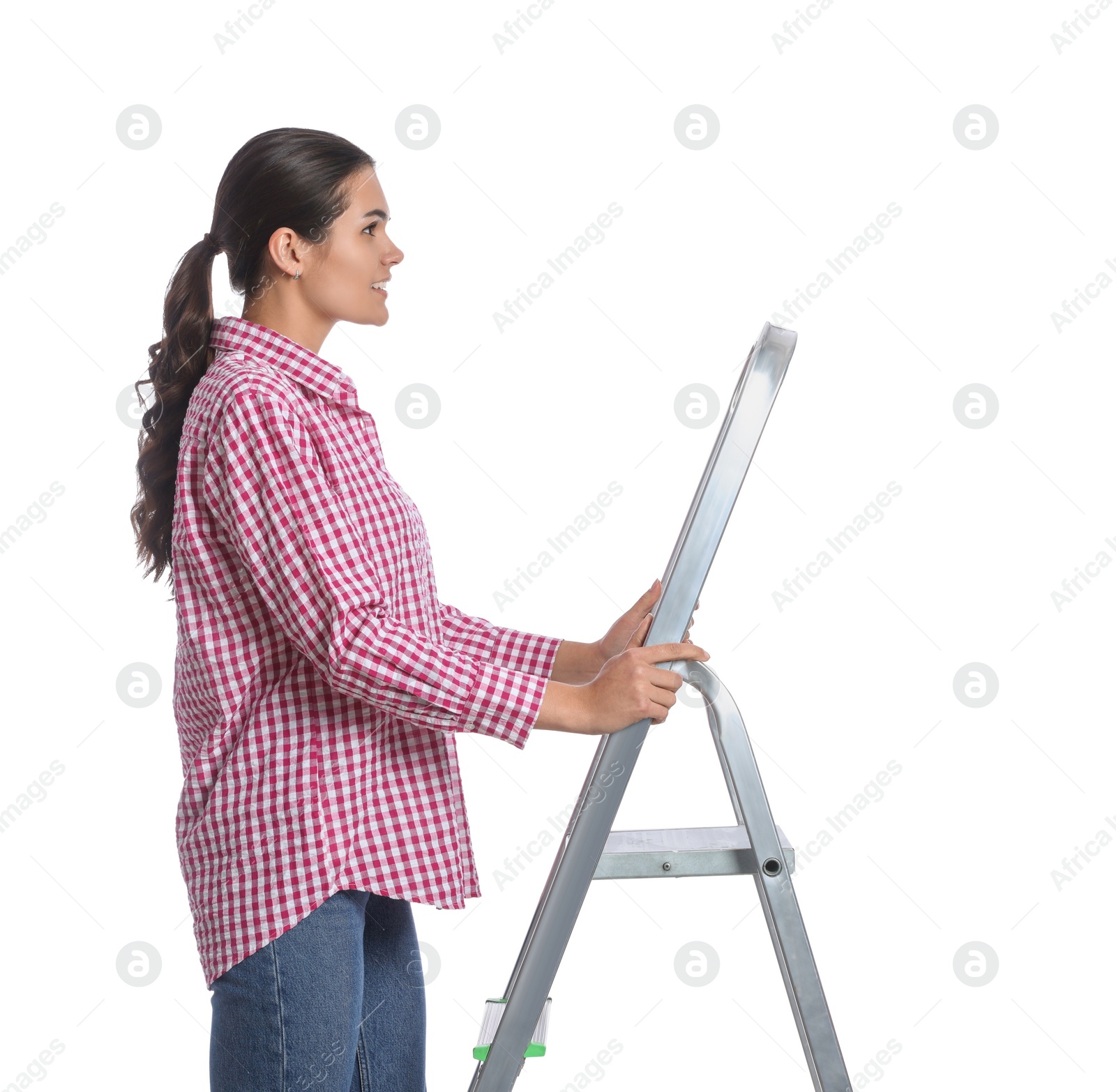 Photo of Young woman on metal ladder against white background