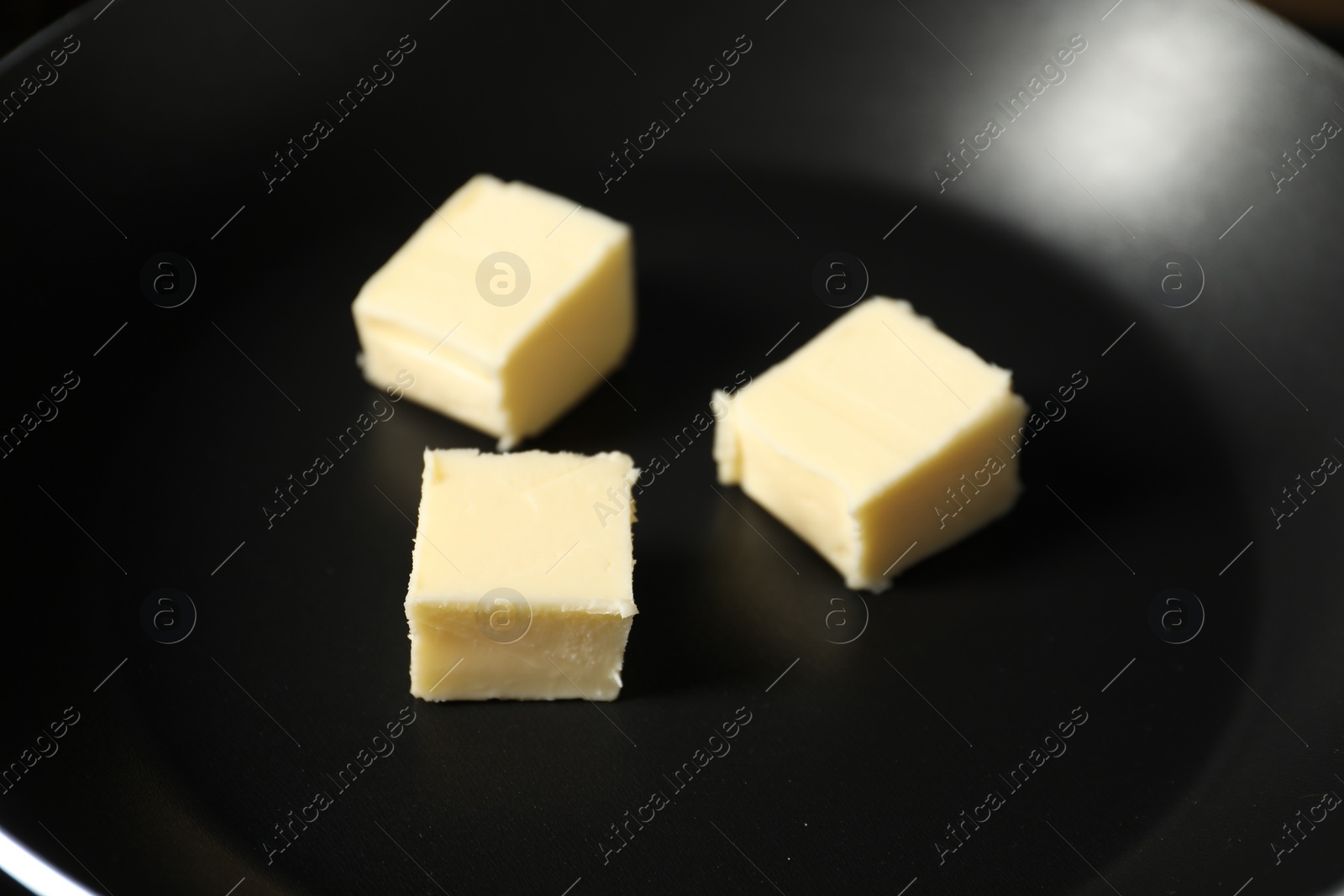 Photo of Melting butter in frying pan, closeup view