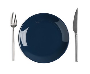 Empty plate, fork and knife on white background, top view
