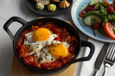 Tasty Shakshouka served on white table, closeup. Traditional Arabic dish