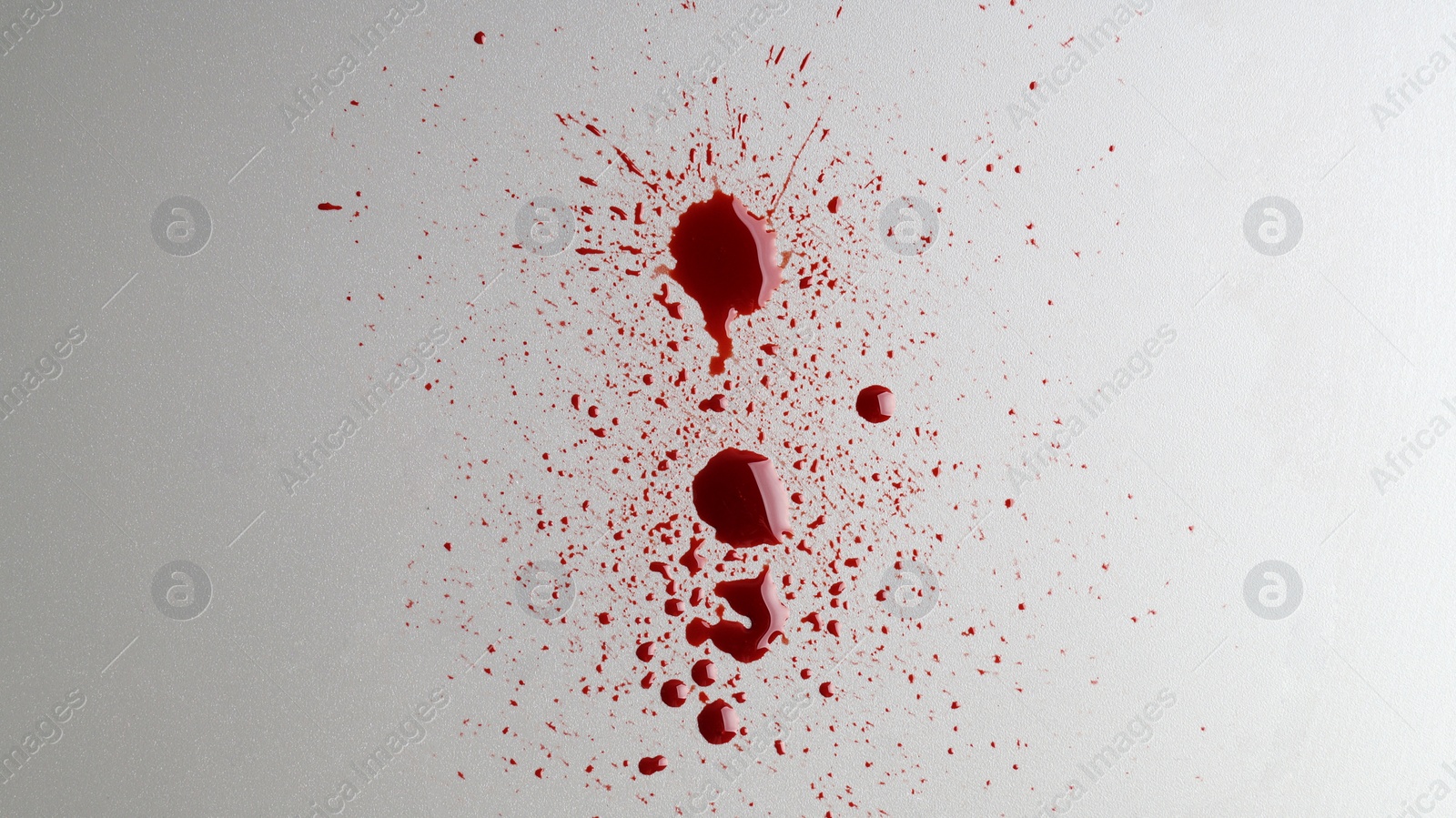 Photo of Stain and splashes of blood on light grey background, top view