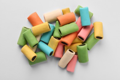 Tasty liquorice candies on light background, top view