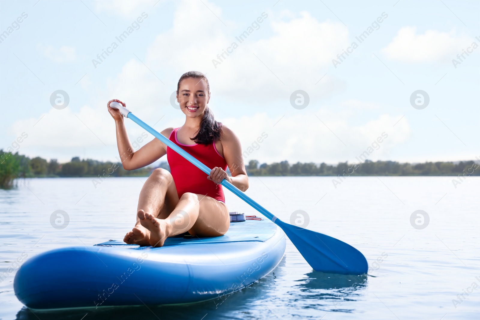 Photo of Woman paddle boarding on SUP board in sea, space for text