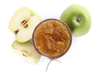 Photo of Glass jar of delicious apple jam and fresh fruits isolated on white, top view