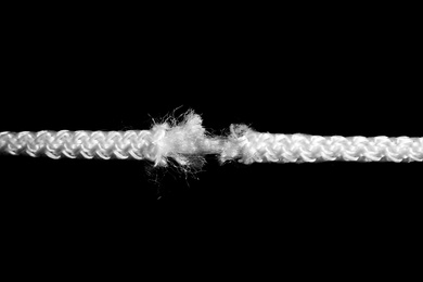 Rupture of white rope on black background