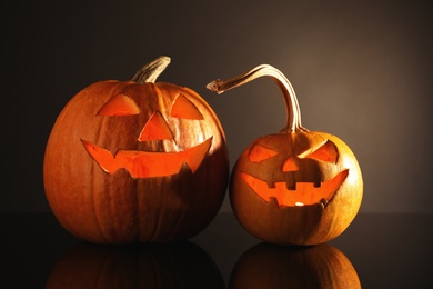 Halloween pumpkin heads. Glowing jack lanterns on dark background