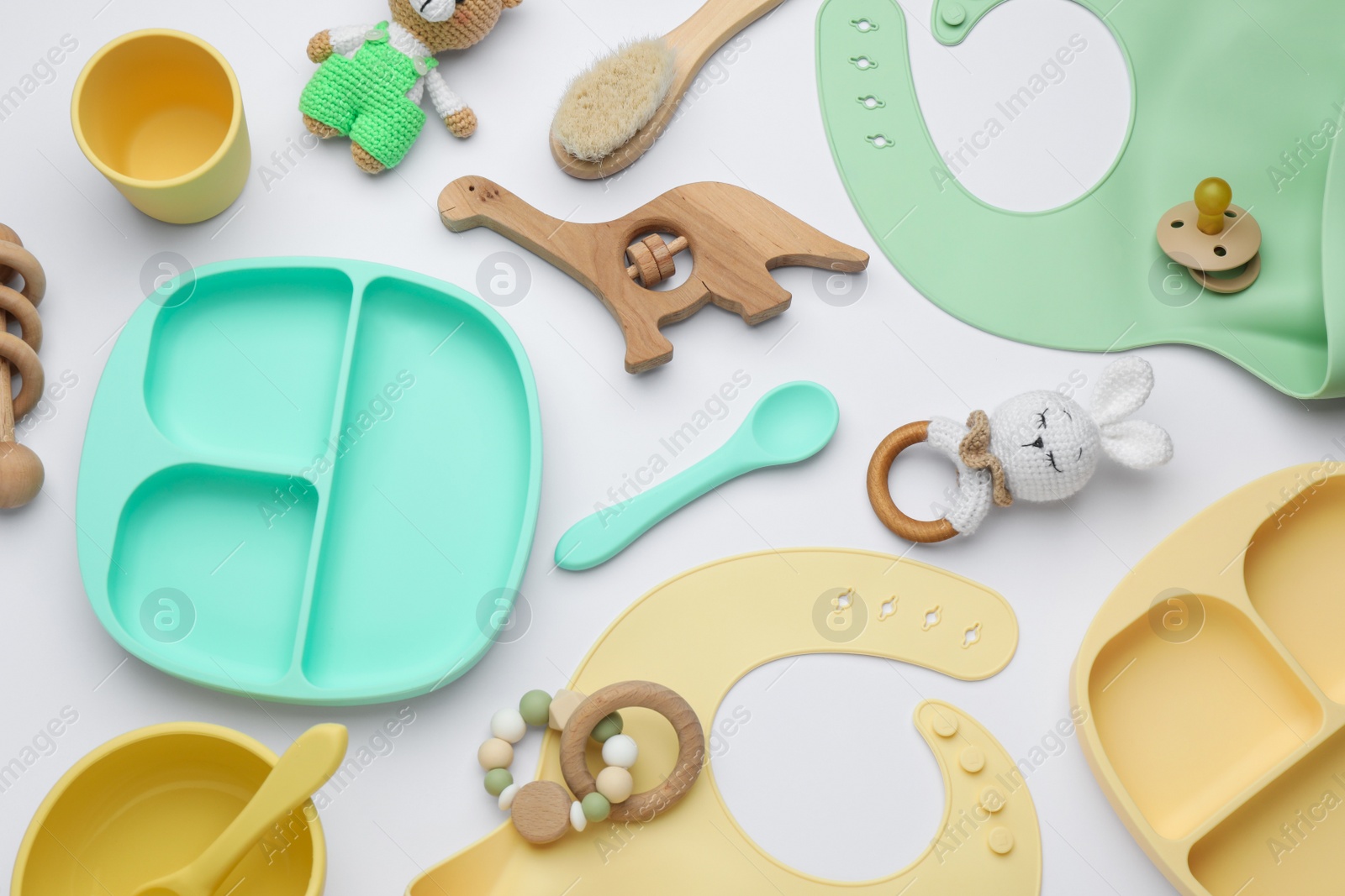 Photo of Composition with baby accessories and bibs on white background, top view