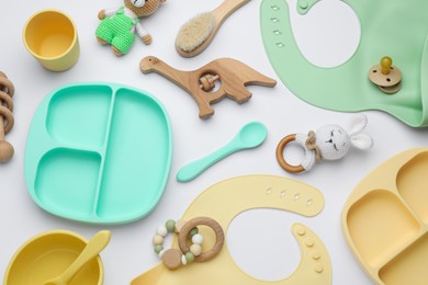 Photo of Composition with baby accessories and bibs on white background, top view