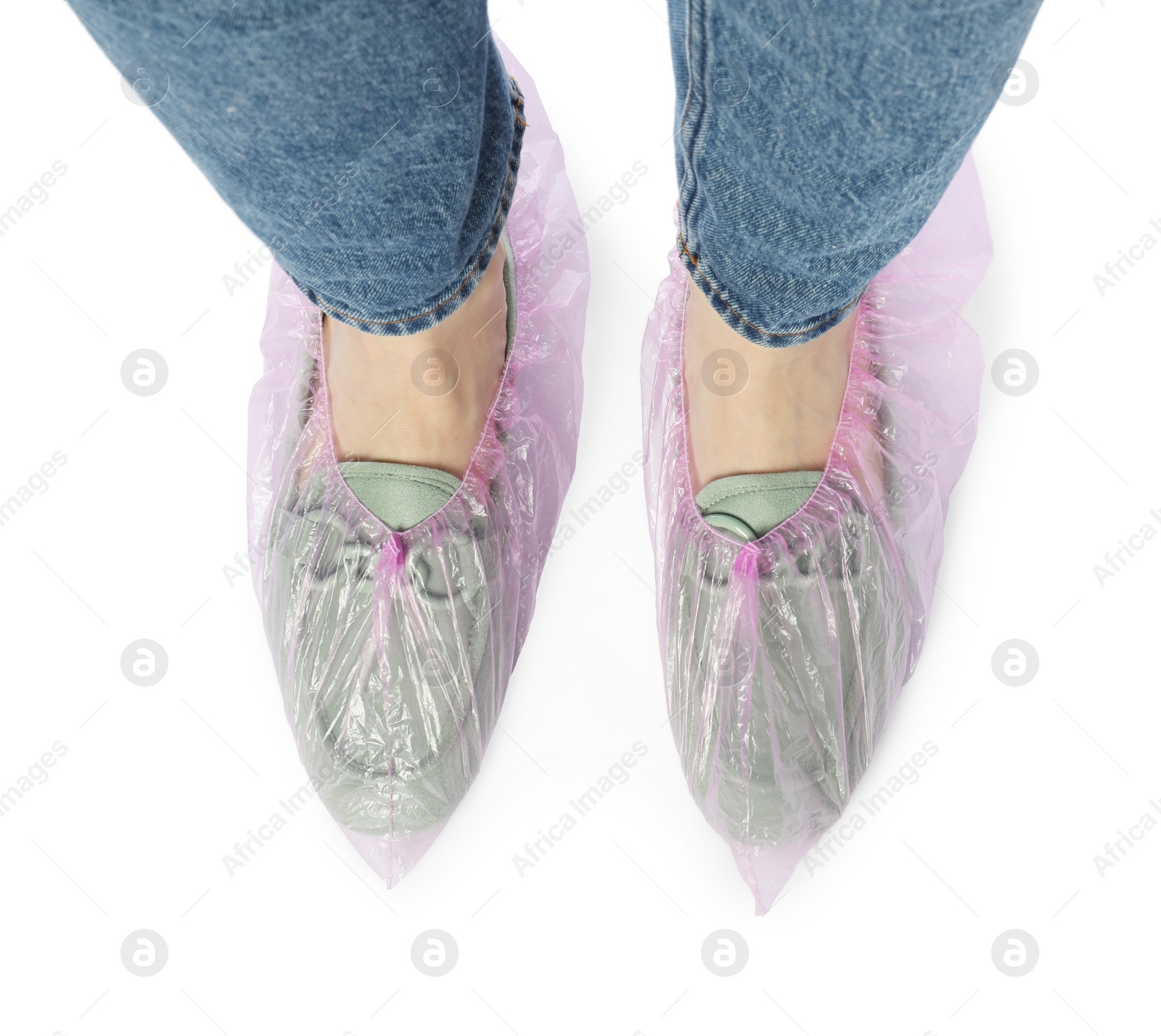 Photo of Woman wearing shoe covers onto her mules against white background, top view