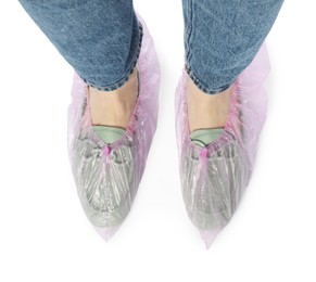 Woman wearing shoe covers onto her mules against white background, top view