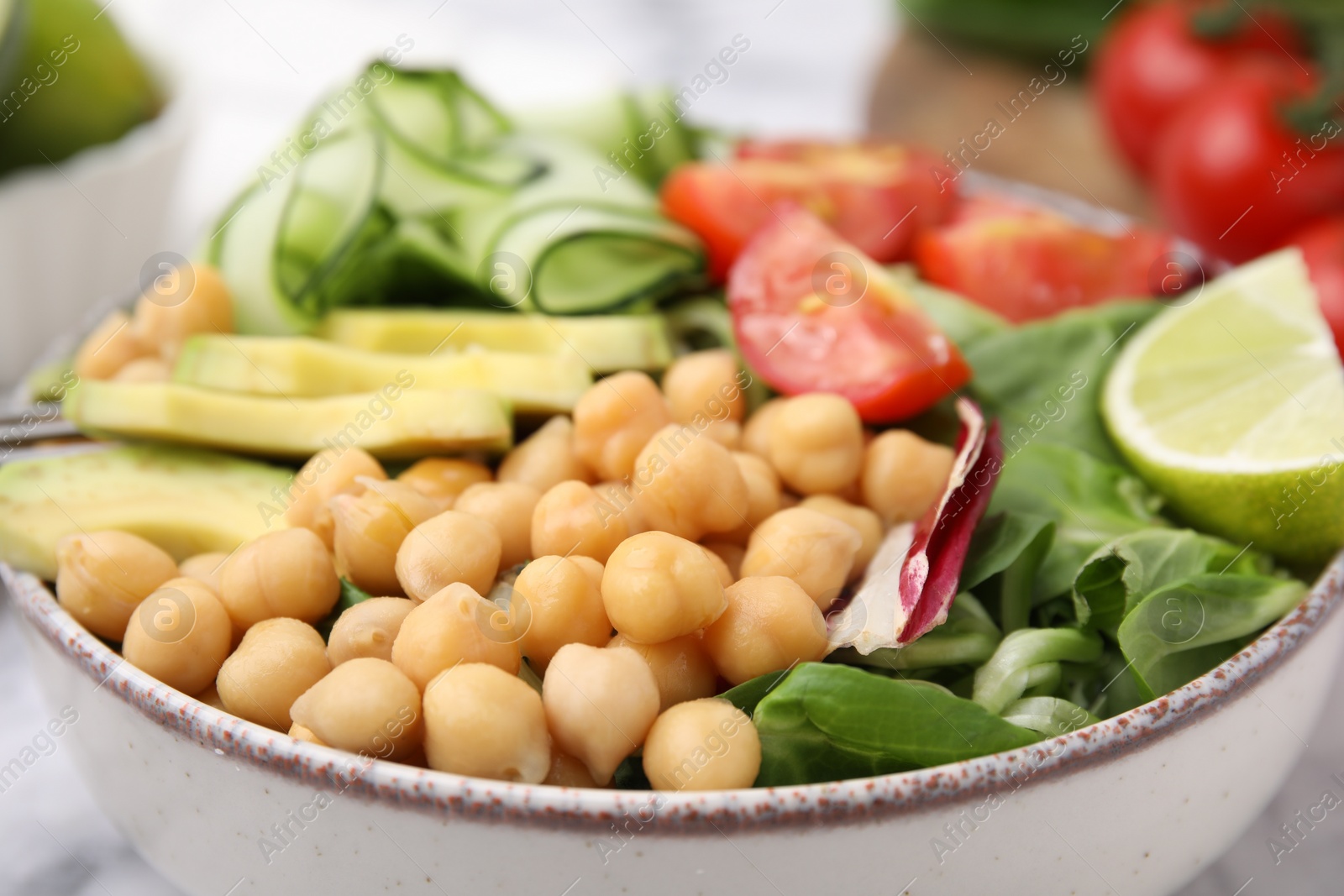 Photo of Tasty salad with chickpeas and vegetables in bowl, closeup