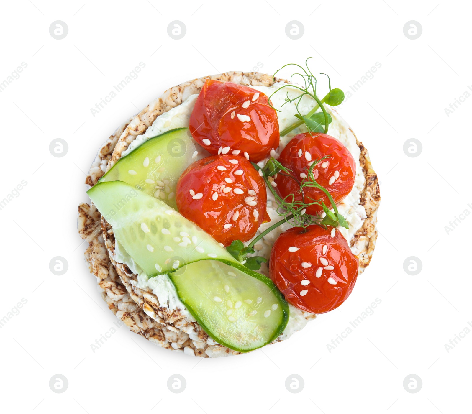 Photo of Crunchy buckwheat cakes with cream cheese, tomatoes and cucumber slices isolated on white, top view