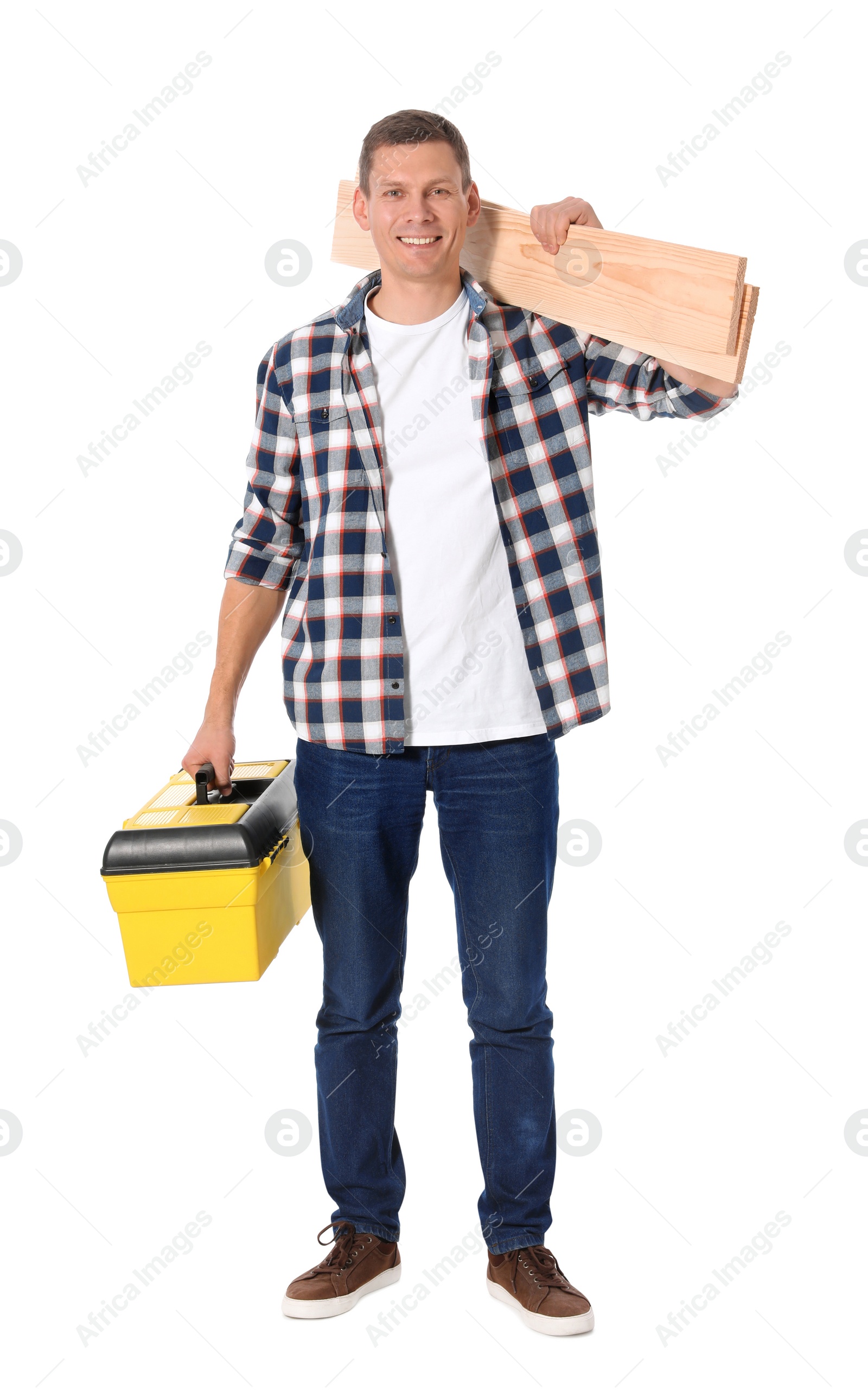 Photo of Handsome carpenter with wooden planks and tool box isolated on white