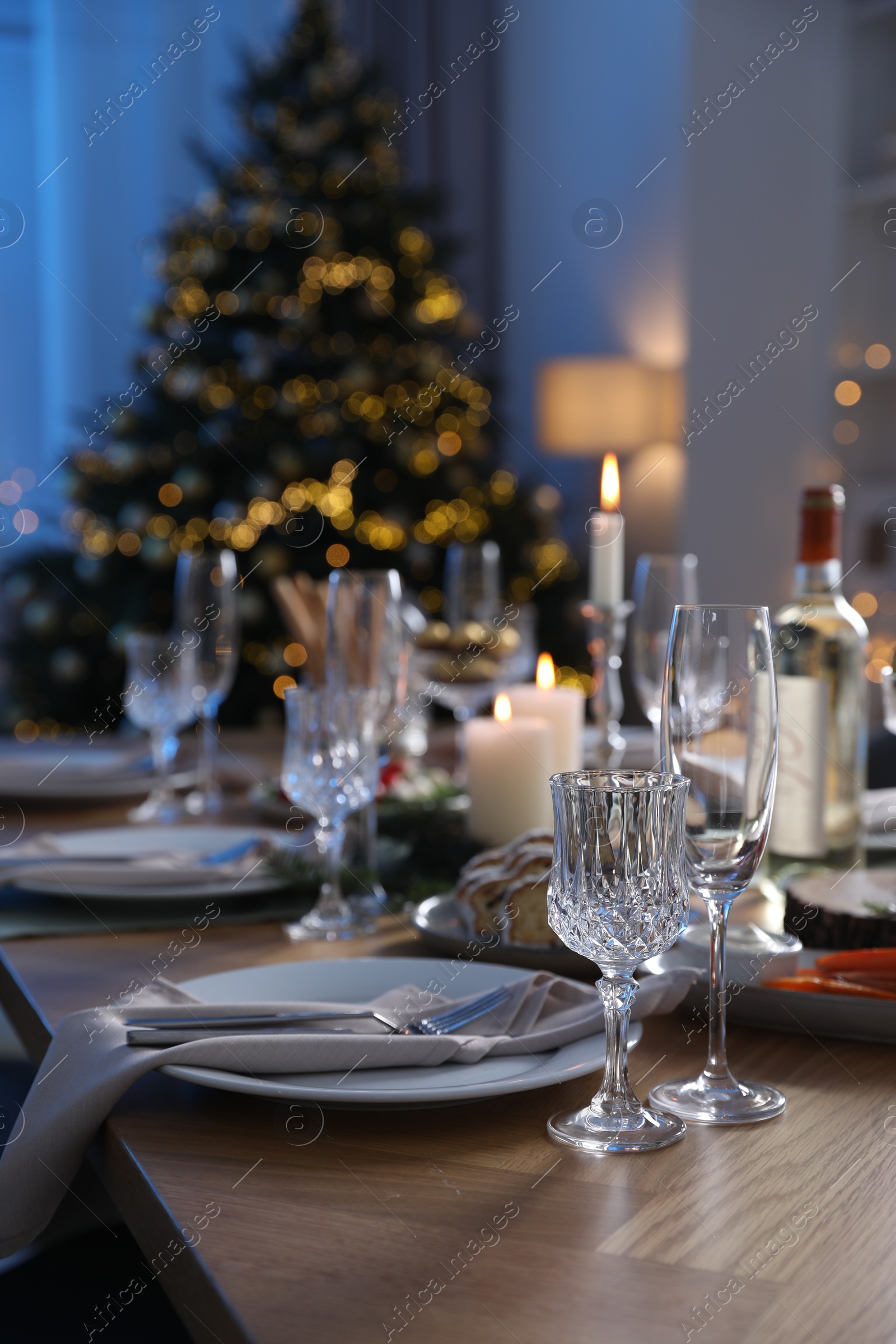 Photo of Christmas table setting with festive decor and dishware in room. Space for text