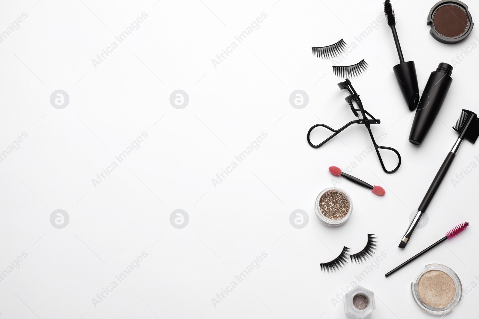 Photo of Composition with eyelash curler and makeup products on white background, top view