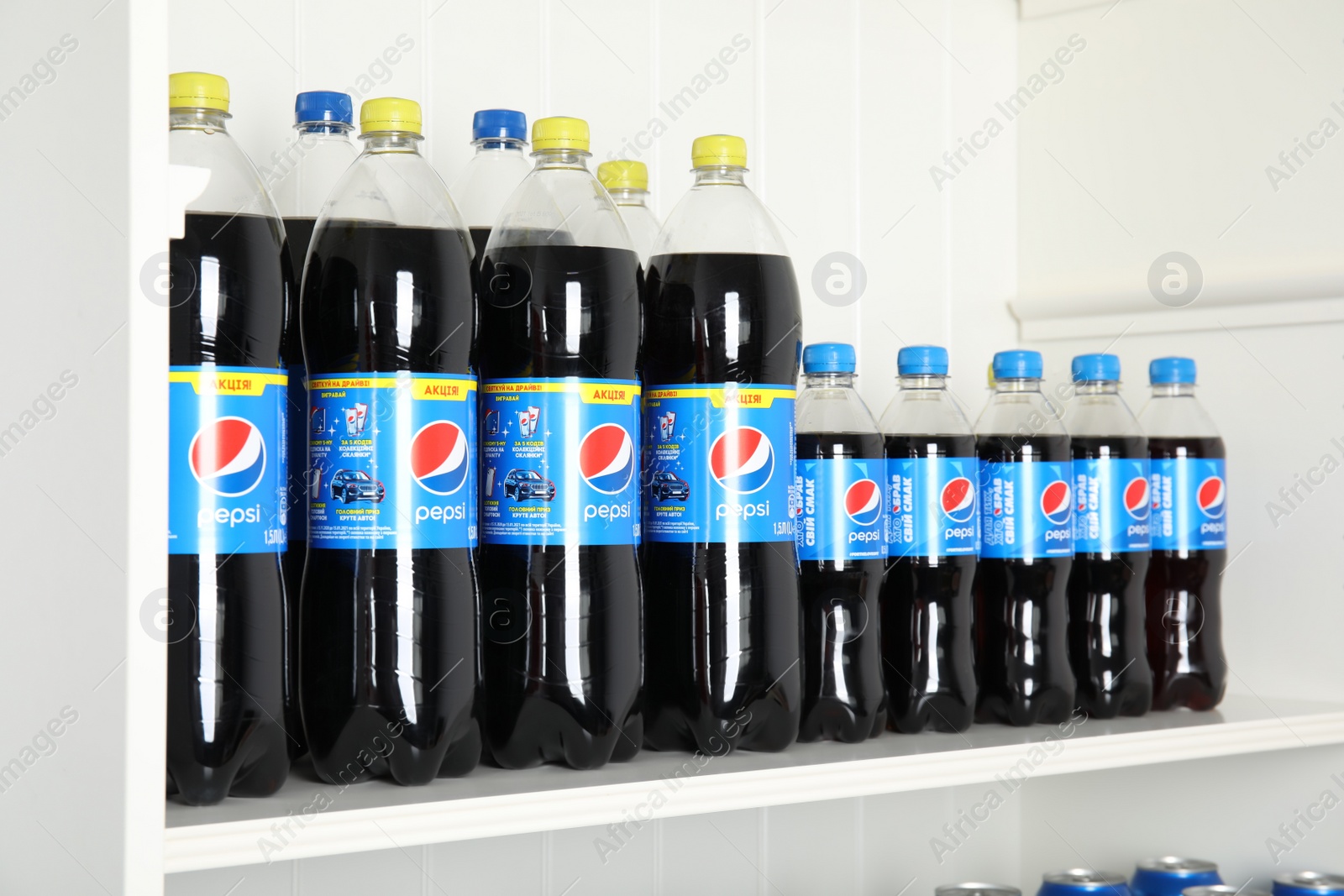 Photo of MYKOLAIV, UKRAINE - FEBRUARY 10, 2021: Bottles of Pepsi on white shelf