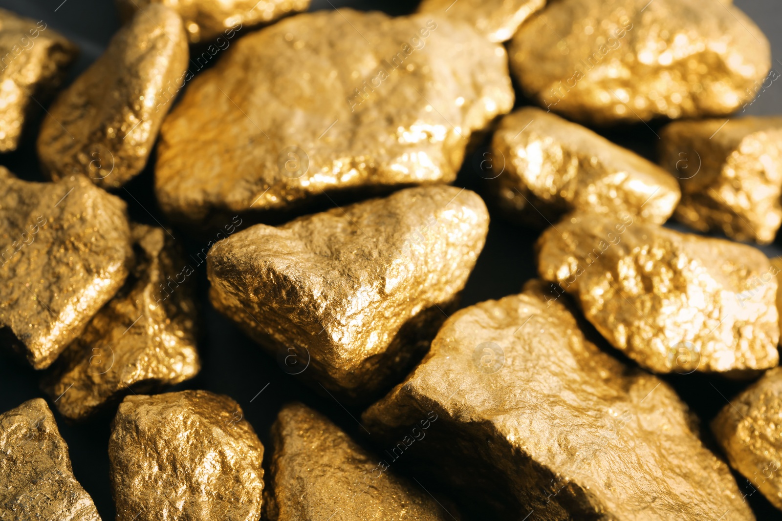 Photo of Pile of gold nuggets as background, closeup