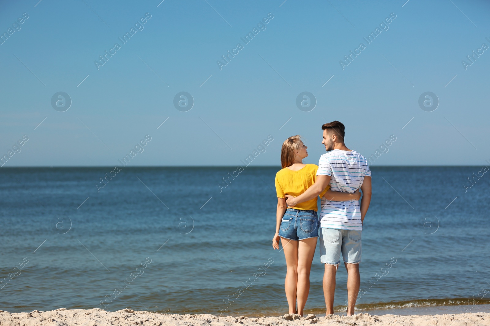 Photo of Happy young couple at beach on sunny day