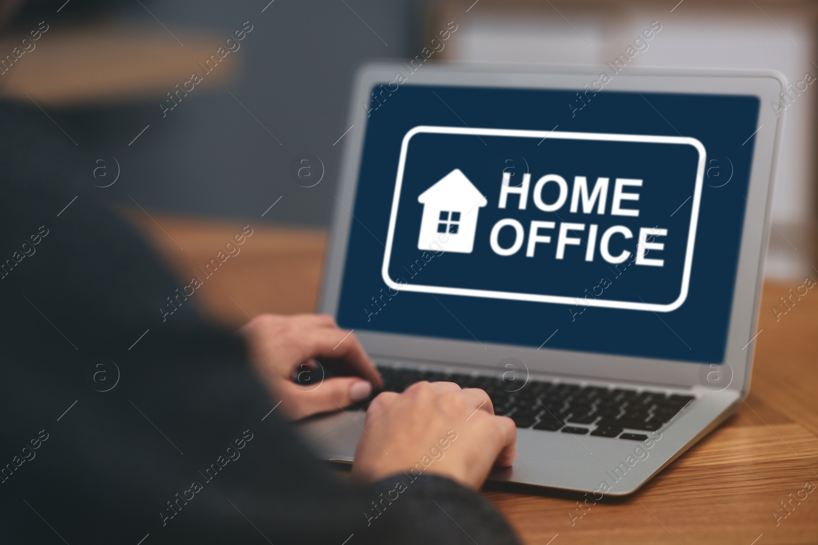 Image of Woman working with laptop at wooden table, closeup. Home office