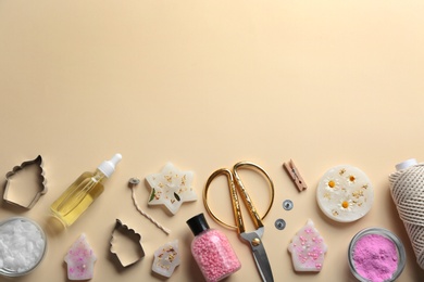 Photo of Flat lay composition with handmade candles and tools on color background. Space for text