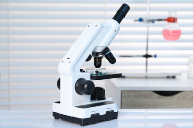 Laboratory analysis. Modern medical microscope on white table indoors