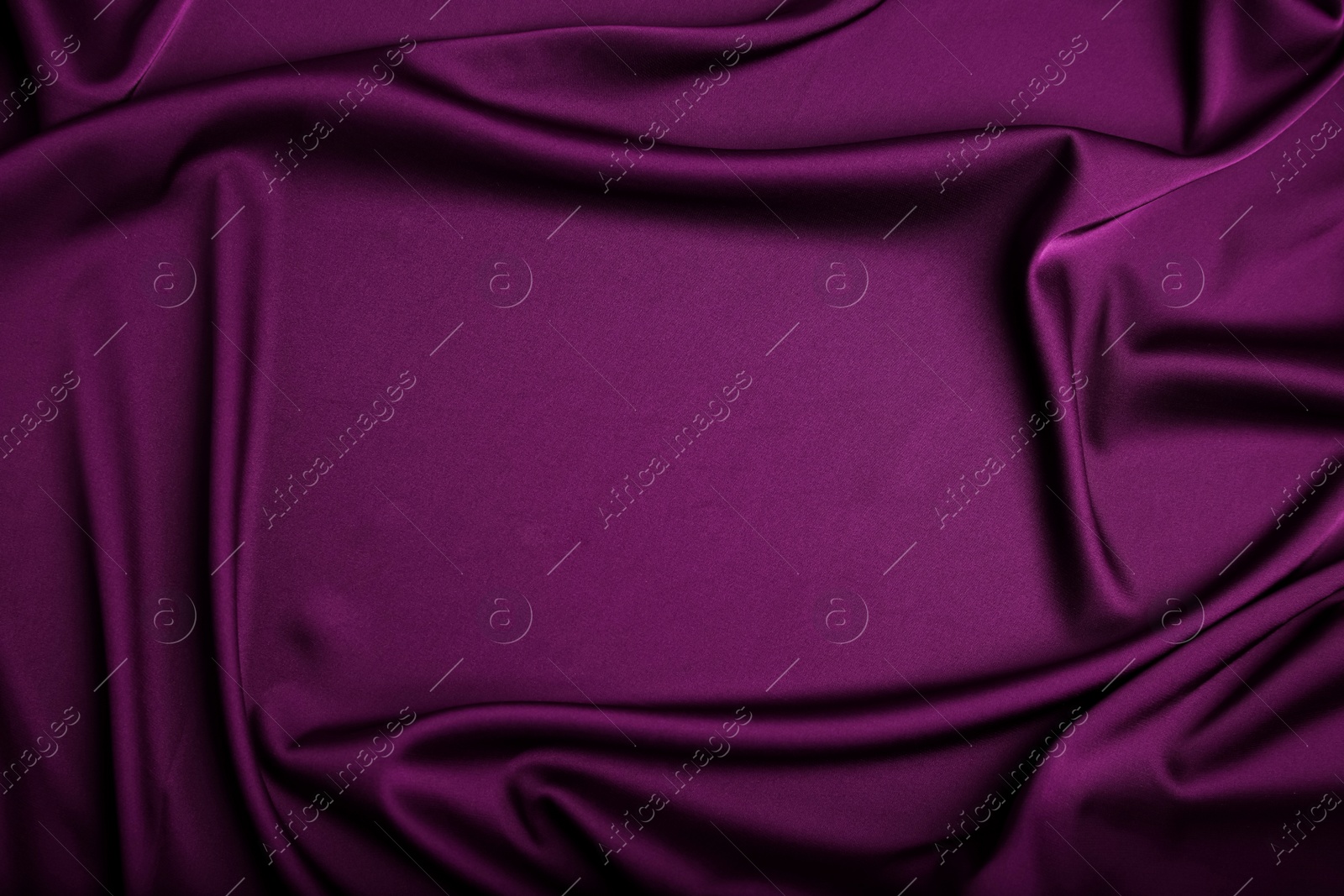 Image of Crumpled purple silk fabric as background, top view. Space for text