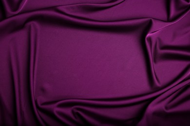Crumpled purple silk fabric as background, top view. Space for text