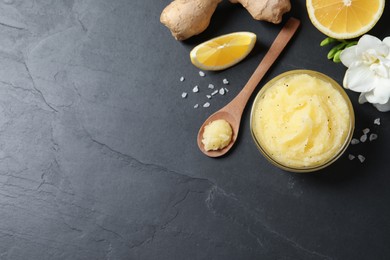 Photo of Flat lay composition with body scrub on black table, space for text