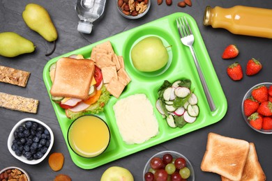 Photo of Flat lay composition with serving tray and tasty healthy food on grey table. School dinner