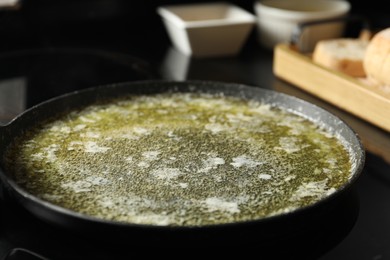 Melted butter in frying pan on table, closeup