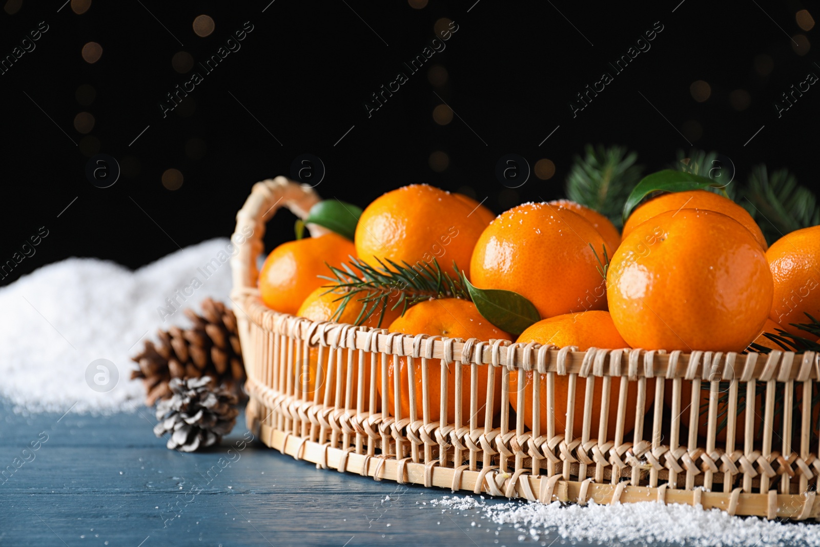 Photo of Tasty fresh tangerines on blue wooden table. Christmas celebration