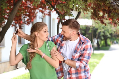 Young couple arguing on street. Problems in relationship