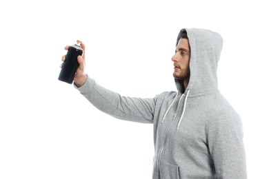 Handsome man holding black can of spray paint on white background