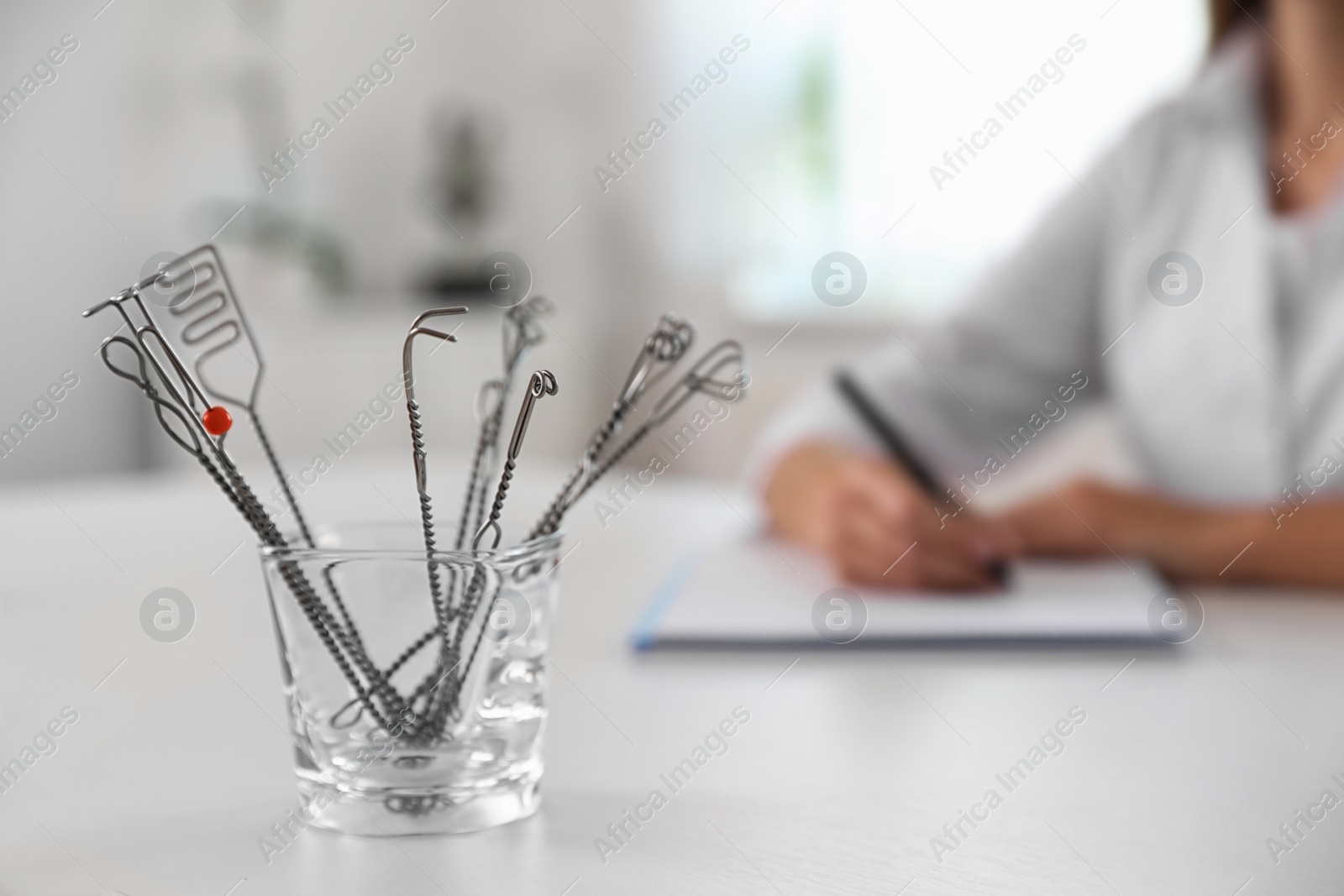 Photo of Set of different logopedic probes in holder on light table, space for text. Speech therapist's tools