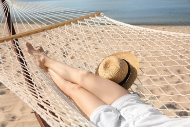 Photo of Young woman relaxing in hammock on beach