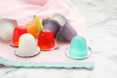 Photo of Tasty bright jelly cups on white marble table