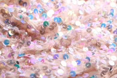 Photo of Beautiful pink fabric with shiny sequins as background, closeup