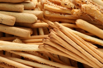 Photo of Delicious grissini sticks as background, closeup view