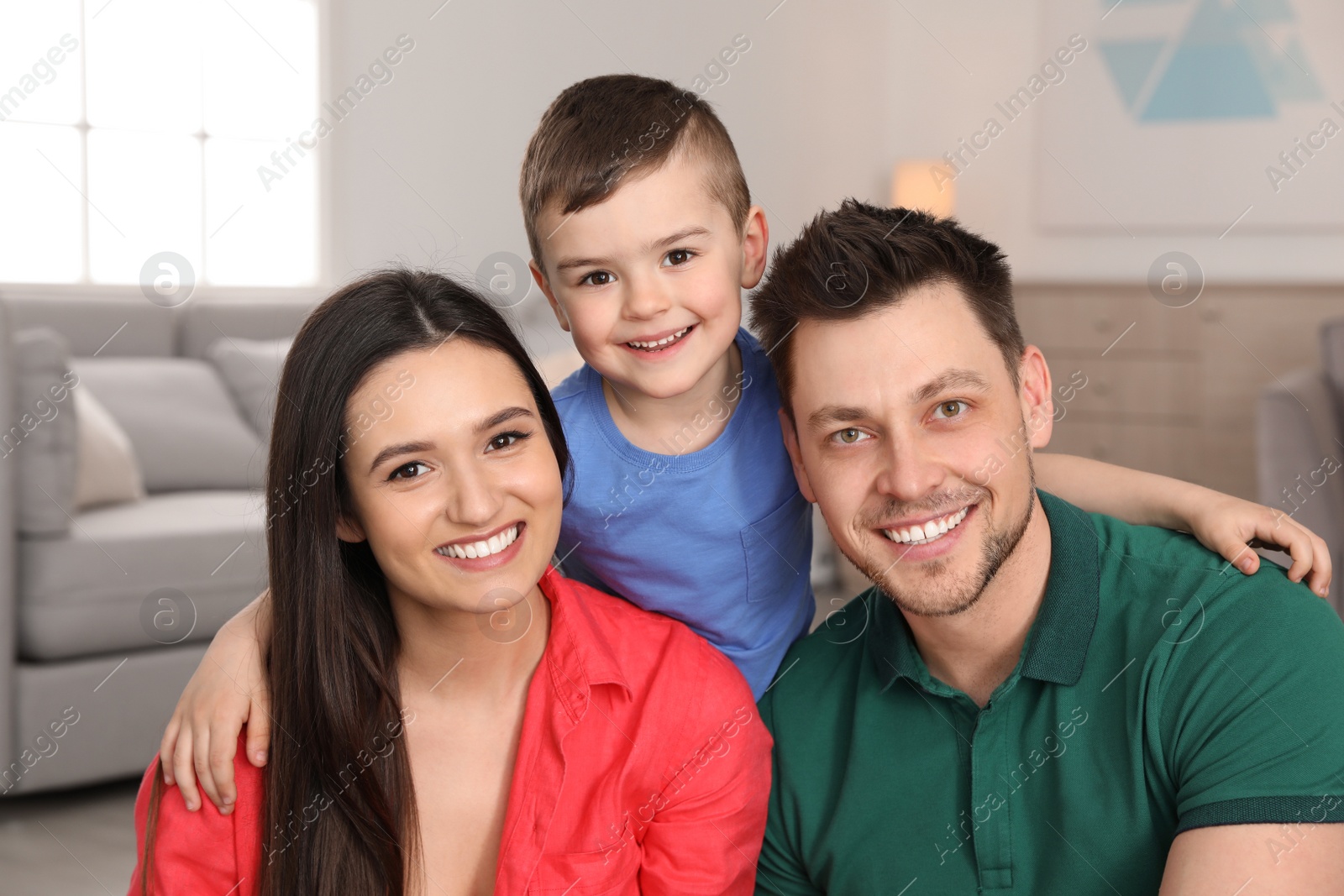 Photo of Happy parents and their son at home. Family portrait