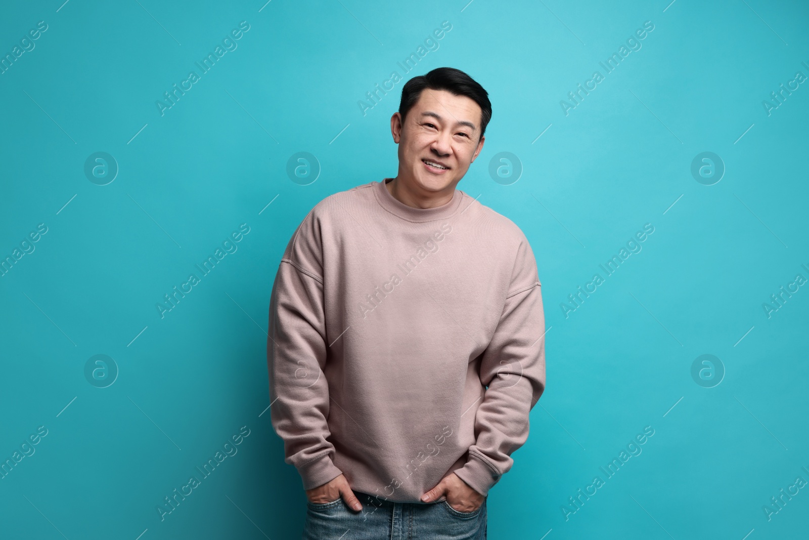 Photo of Portrait of happy man on light blue background