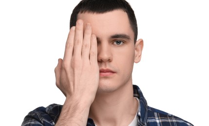 Photo of Young man covering his eye on white background