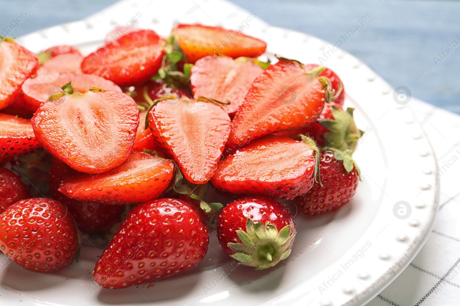 Photo of Plate with ripe strawberries on table, closeup