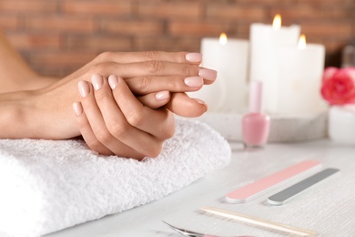 Photo of Woman waiting for manicure at table, closeup with space for text. Spa treatment