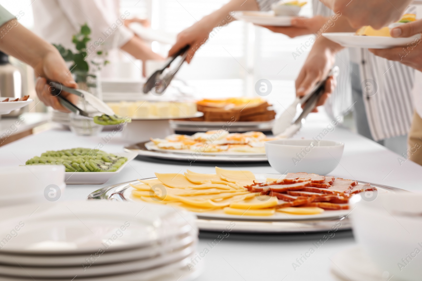 Photo of People taking food during breakfast, closeup. Buffet service