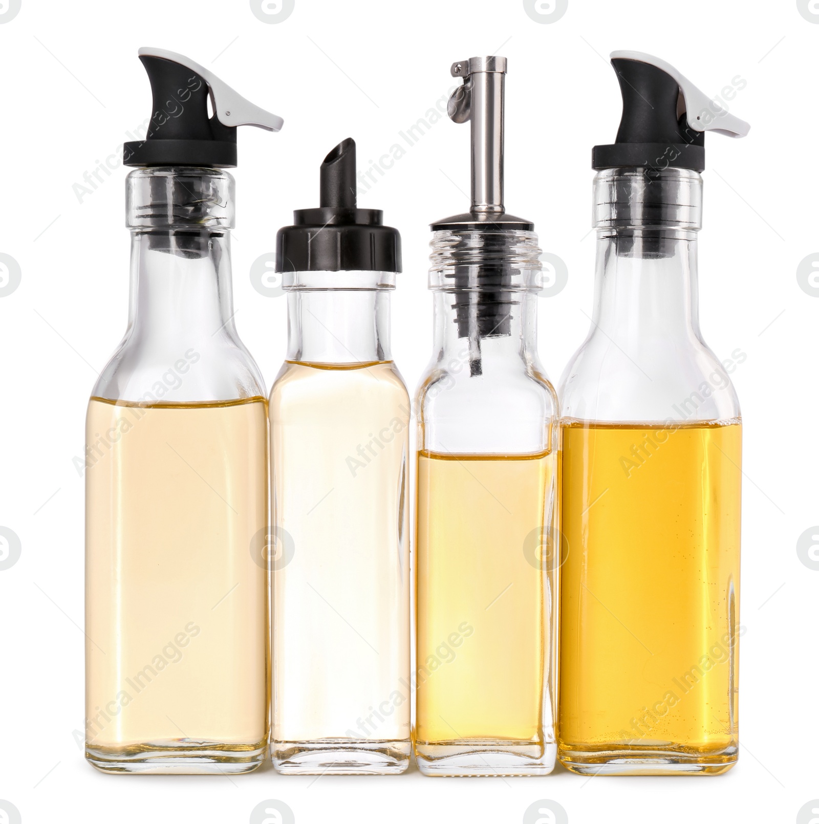 Photo of Different glass bottles with cooking oil on white background