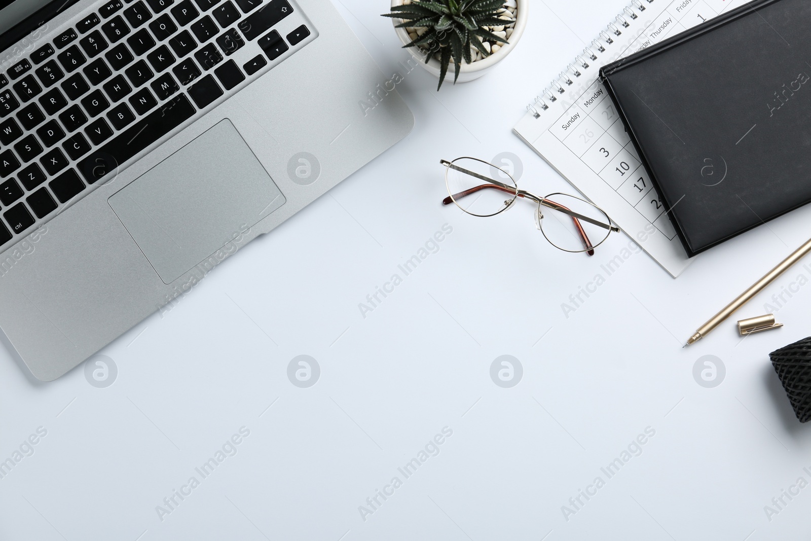 Photo of Composition with laptop, glasses and stationery on white background, top view