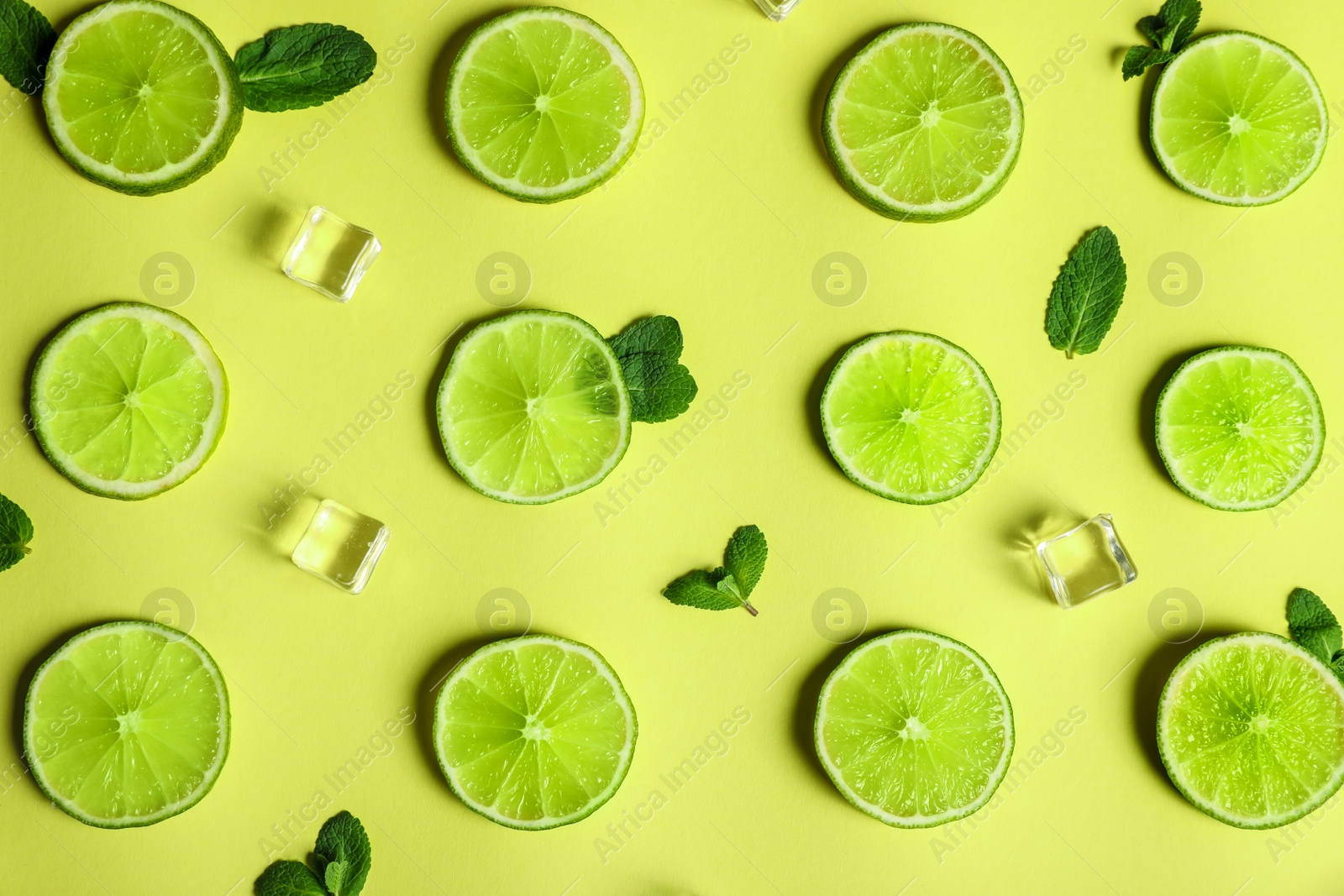 Photo of Flat lay composition with fresh juicy limes on yellow background